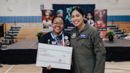 Young girl receiving a scholarship check